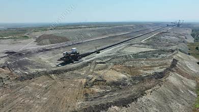 Top shot of a large bucket-wheel excavator in a lignite (brown-coal) mine. ?erial view. Coal transshipment.