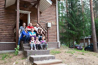 Large family sitting on the house porch together