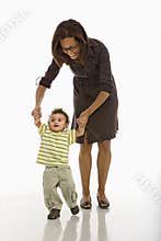 Baby walking with mom.
