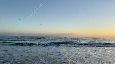 Calm ocean waves reaching the beach