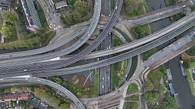 Aerial drone view of a multi-level highway intersection with moving cars in the city of Rotterdam, The Netherlands