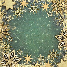 Christmas Gold Star and Snowflake Decorations on Green Background