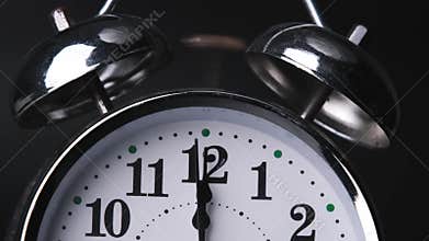 The old alarm clock was ringing at 12:00 AM or 12:00 PM.