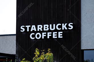 Starbucks Coffee logo sign on an establishment building.