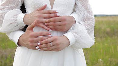 Bride and bridegroom hugs each other's wedding rings