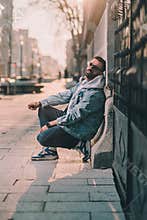 man in hoodie on a street sad