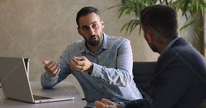 Millennial sales manager consulting client in office
