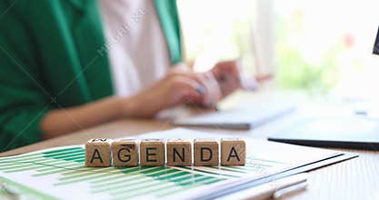 On the table wooden cubes the inscription agenda