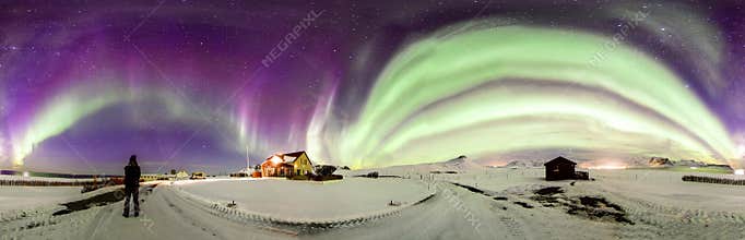 Panoramic view of The Northen Lights with sonwy foreground
