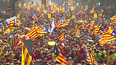 Crowd of People with Catalan Flags on the Street