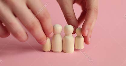 Wooden figurines of young family with adopted children