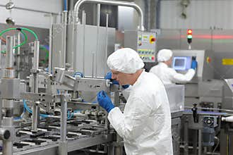 two workers at production line in plant