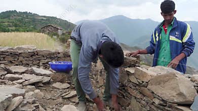 June 28th 2023,Nagthat, Uttarakhand, India. Local workers constructing a traditional home with stone in a countryside village.