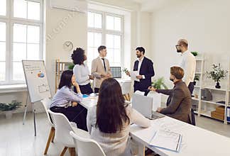Delegation of specialists in office actively conducts dialogue, exchanging ideas and strategies.