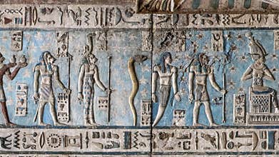 Ancient Egyptian hieroglyphs and bas-reliefs close-up in Dendera temple or Temple of Hathor. Egypt. Dendera Temple