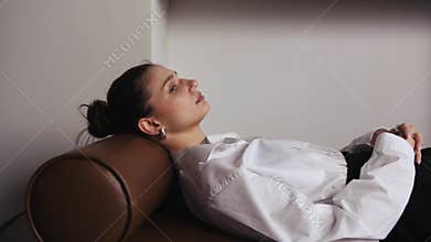 Woman asking help a psychiatrist while lying on a sofa at doctor cabinet. Mental advisor concept.