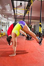 Fitness TRX training exercises at gym woman and man