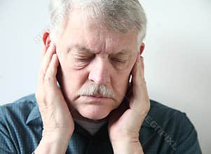 Senior with pain in front of ears