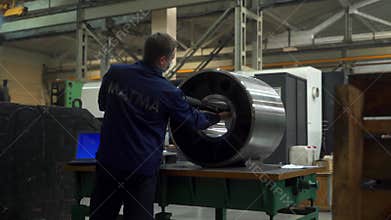2021-09-23 - Mariupol, Ukrane. Magma factory. Technician operates Romer arm in industrial factory, precision dimension