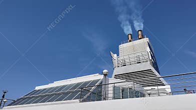 Smoking chimney of a ferry in the harbor, Italy