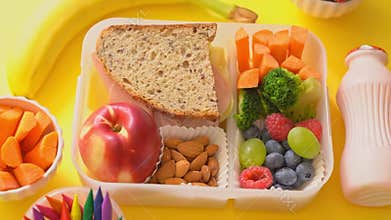 Back to school concept - school lunch with colorful pensils on yellow background
