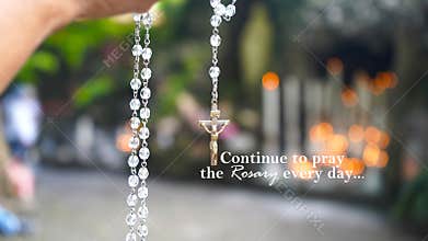 Rosary inspirational quote - Continue to pray the Rosary every day. With praying hand holding rosary beads with Jesus Christ cross