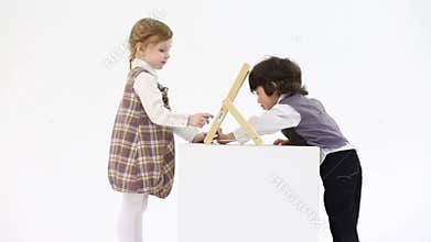 Little happy girl and boy play with abacus on big