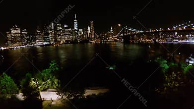 Riverscape with illuminated Brooklyn Bridge and