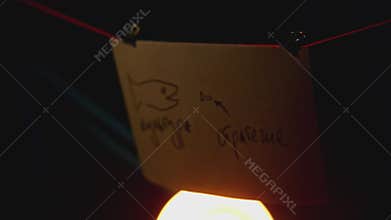 Drawings on stickers in office. Stock footage. Rebus with pictures on pieces of paper in guest room. Night quest with