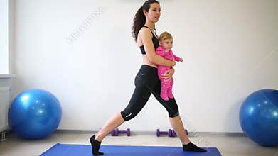 Young mother with her daughter crouches on one