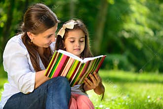 Happy latino family reading book