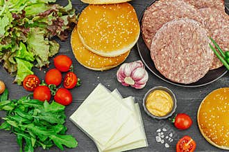 Burger patties. Beef cutlets, buns, vegetables and sauce. Homemade American classic