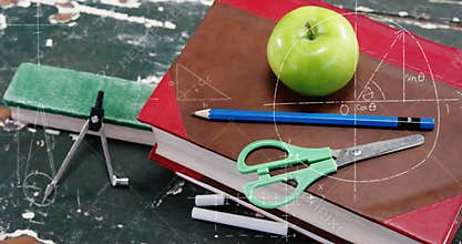 Image of mathematical formulae over apple, school items and books