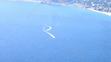 Two scooters float on water near with coast, time