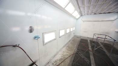 Atomizer in empty paint-spraying booth with metal