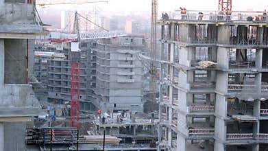Workers constructing blocks during the day.