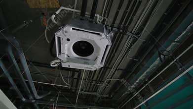 Air conditioning machine installed on metal beams on ceiling