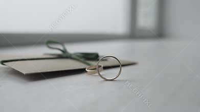 The wedding ring is rolling on the table