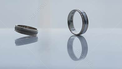 The wedding ring spins around its axis and falls