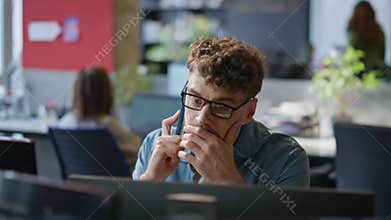 Sales professional speaking mobile phone client at contemporary office closeup