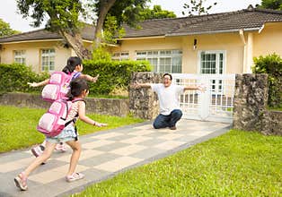 Happy family in front of house