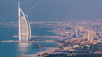 Aerial View of Jumeirah Beach and Dubai skyline with Burj Al Arab day to night timelapse, UAE