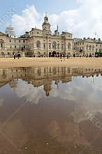 Horse Guards Parade seen reflected in a puddle.