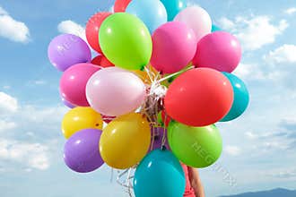 Bunch of balloons held by a man outdoor