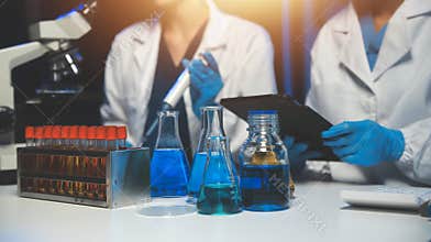 professional chemist woman laboratory using scientific microscope for science research, chemistry scientist with microbiology