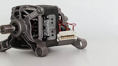 Asynchronous electric motor from a washing machine on a white background, close-up, isolate.