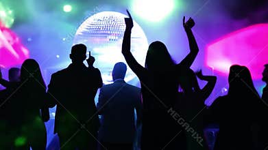 People dancing at nightclub with disco ball