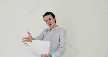 Man with expression reads script on white background