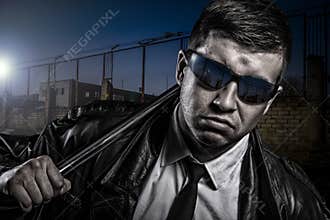Close up portrait of stylish secret dangerous man with steel baton