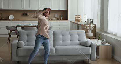 Happy active young Indian woman dancing at home